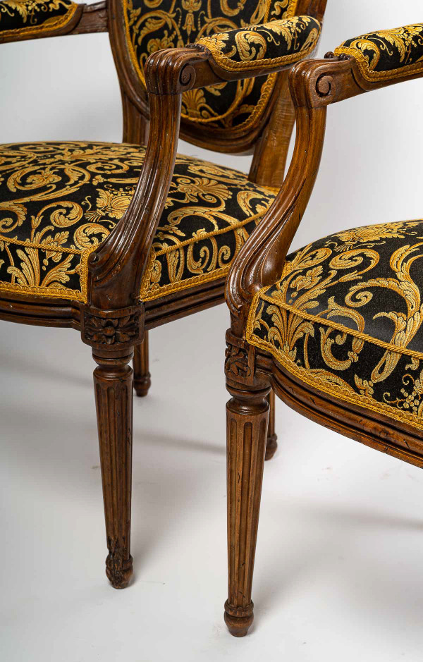 Pair of Louis XVI-style armchairs with medallion backs in carved and waxed molded natural wood