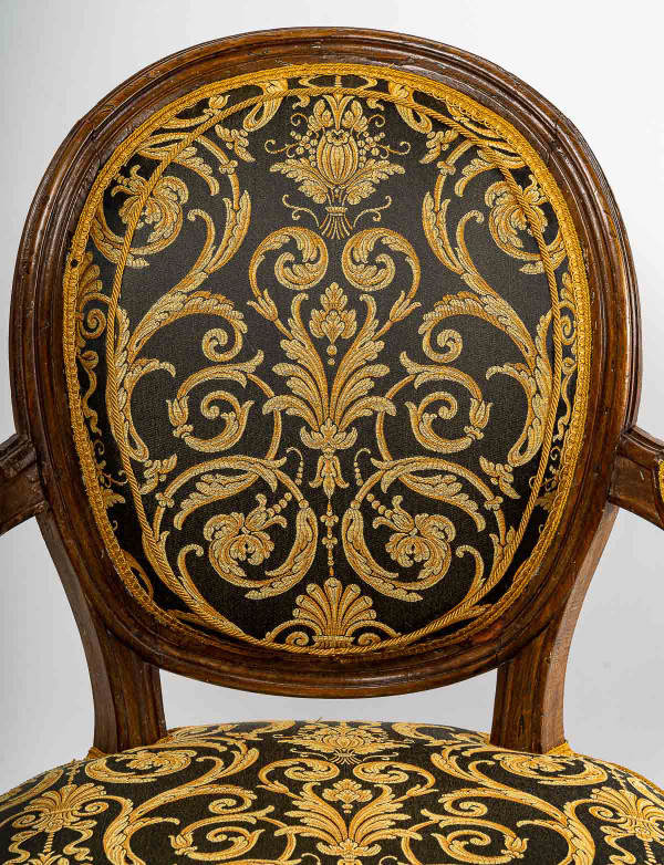 Pair of Louis XVI-style armchairs with medallion backs in carved and waxed molded natural wood