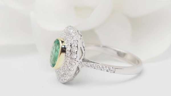 Surrounding ring in two-tone gold, oval emerald and diamonds