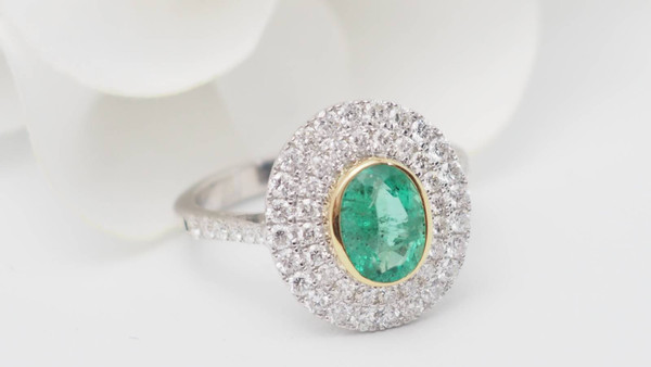 Surrounding ring in two-tone gold, oval emerald and diamonds