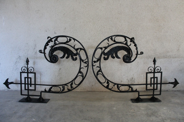 Pair of large wrought iron gallows with Louis XVI style scrollwork, 20th century