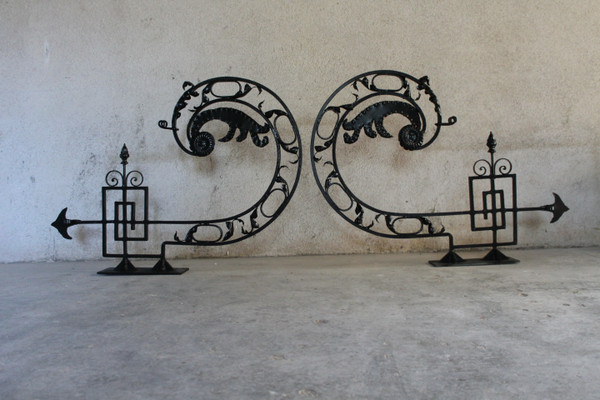 Pair of large wrought iron gallows with Louis XVI style scrollwork, 20th century