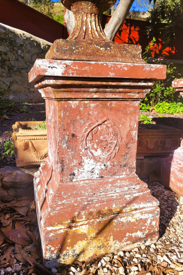 Set of 4 large cast iron garden vases on terracotta bases, 19th century