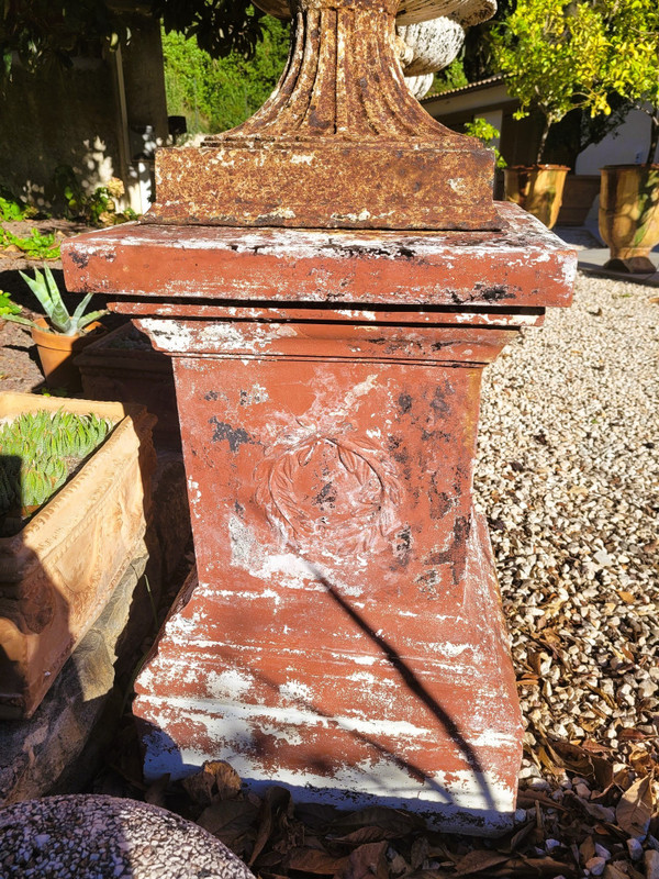 Set of 4 large cast iron garden vases on terracotta bases, 19th century