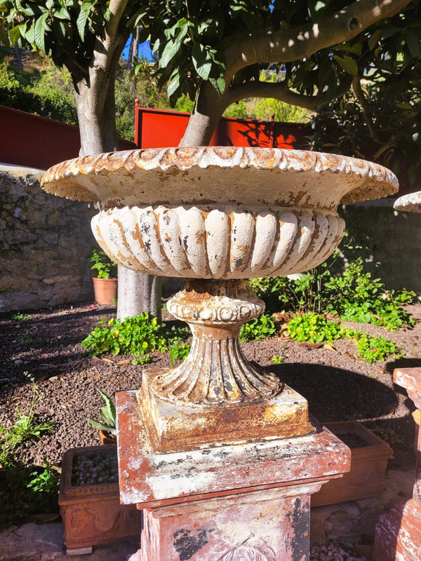 Set of 4 large cast iron garden vases on terracotta bases, 19th century