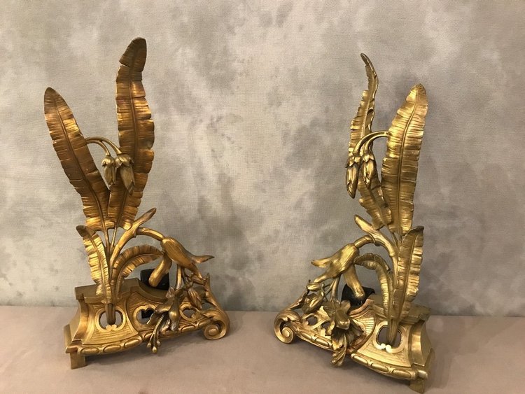 Pair of bronze andirons with facade decoration, 19th century