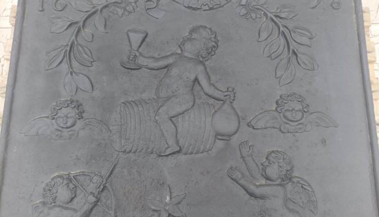 Large 17th century cast iron fireplace plate decorated with cherubs