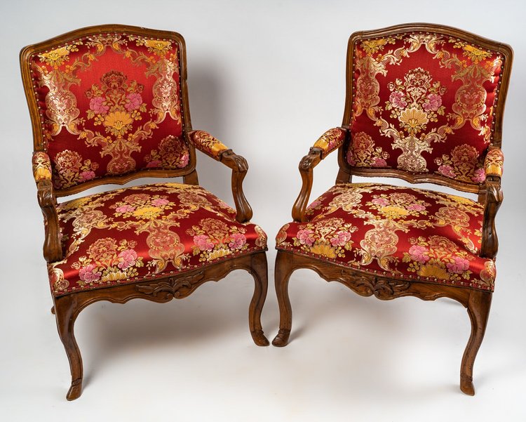 Paire de larges fauteuils en noyer mouluré et sculpté d’époque Régence vers 1720