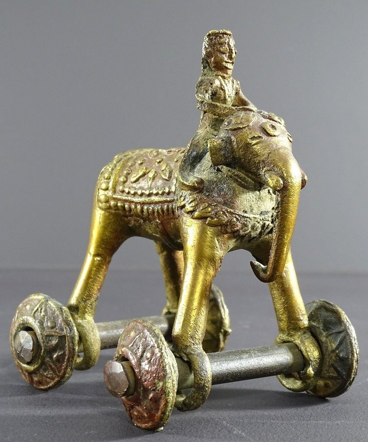 India, Early 20th Century, Bronze Cornac toy perched on an elephant.