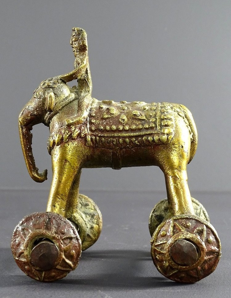 India, Early 20th Century, Bronze Cornac toy perched on an elephant.