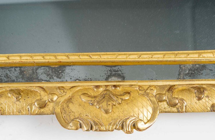 A French Regence period giltwood openwork pediment mirror circa 1720