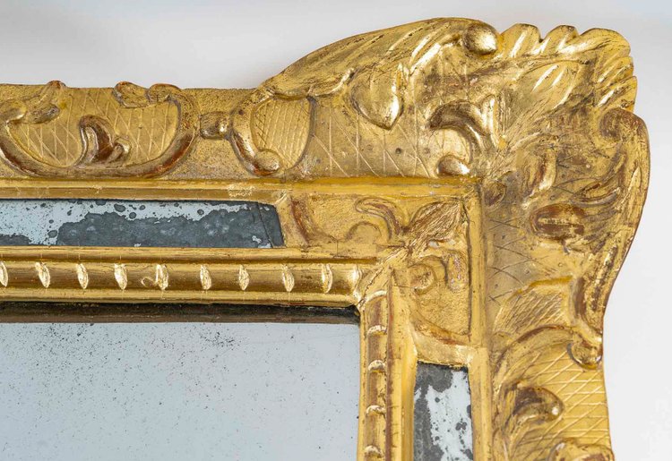 A French Regence period giltwood openwork pediment mirror circa 1720