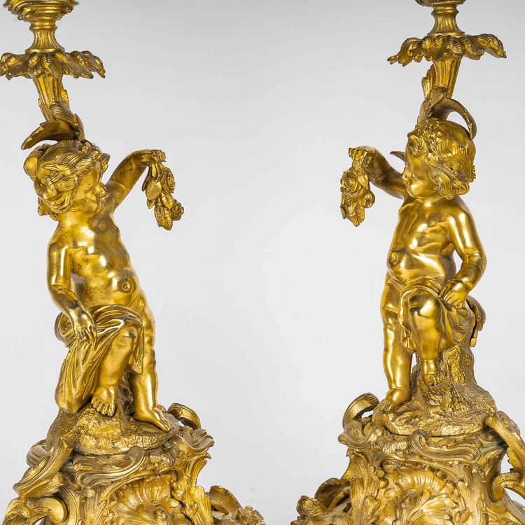 A pair of Napoleon III period gilt bronze Putti candlesticks, mounted as lamps