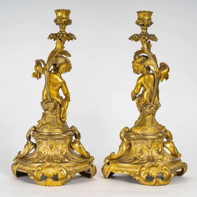 A pair of Napoleon III period gilt bronze Putti candlesticks, mounted as lamps