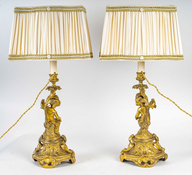 A pair of Napoleon III period gilt bronze Putti candlesticks, mounted as lamps