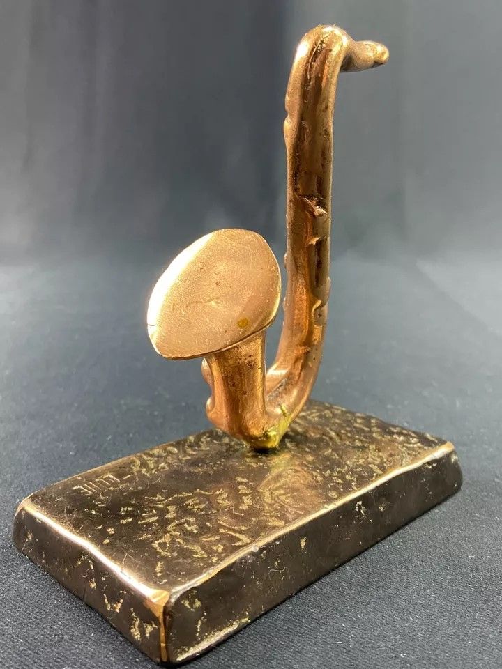 Carved saxophone subject in bronze signed Yves Lohé