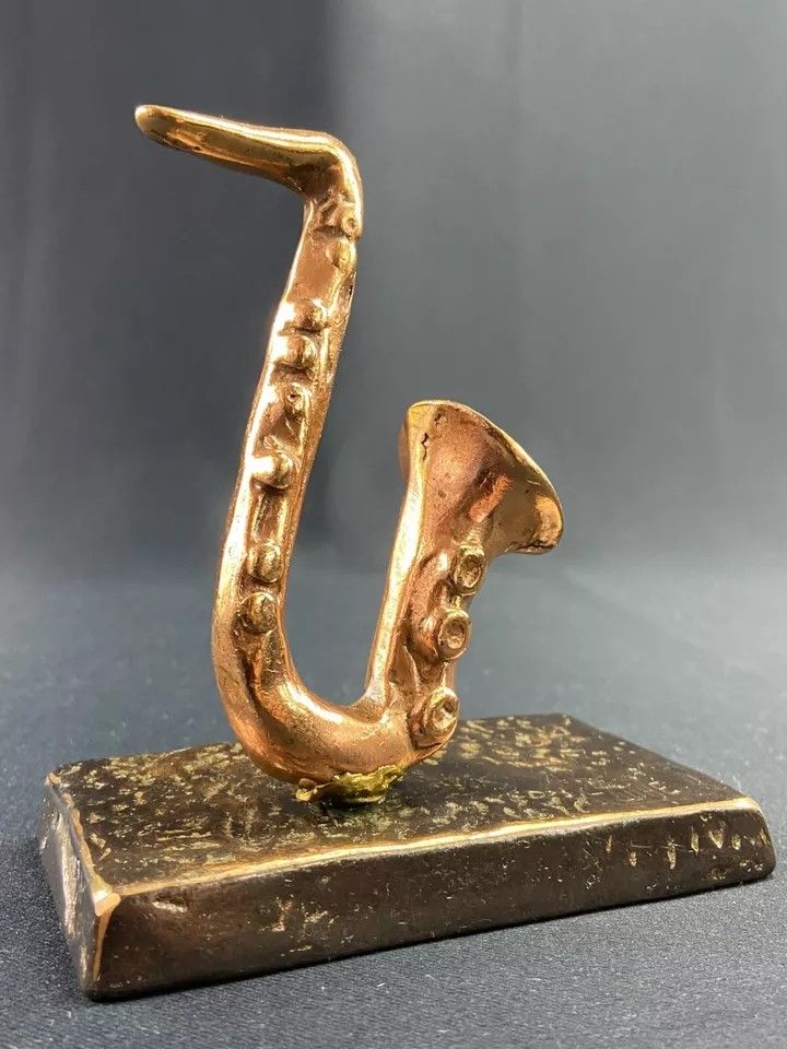 Carved saxophone subject in bronze signed Yves Lohé