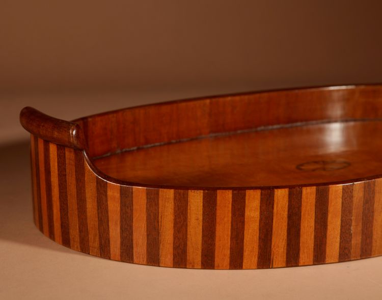 Unusual oval top in inlaid mahogany and satinwood.