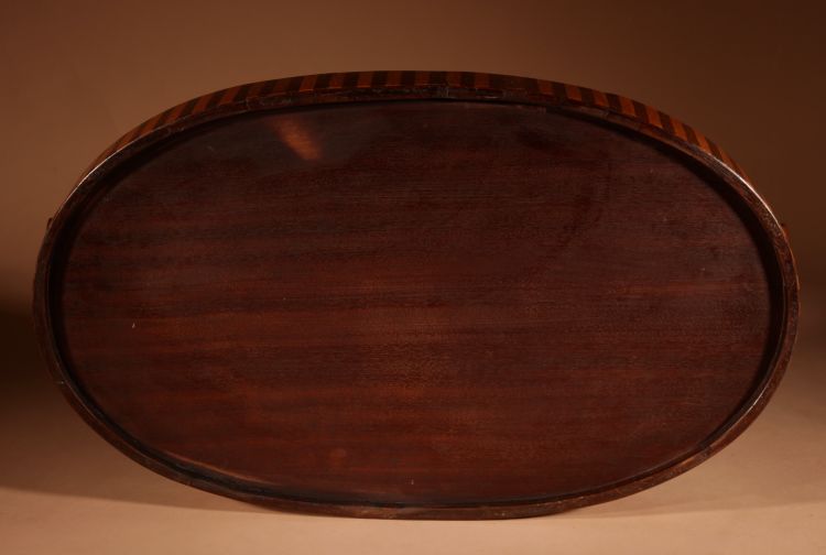 Unusual oval top in inlaid mahogany and satinwood.