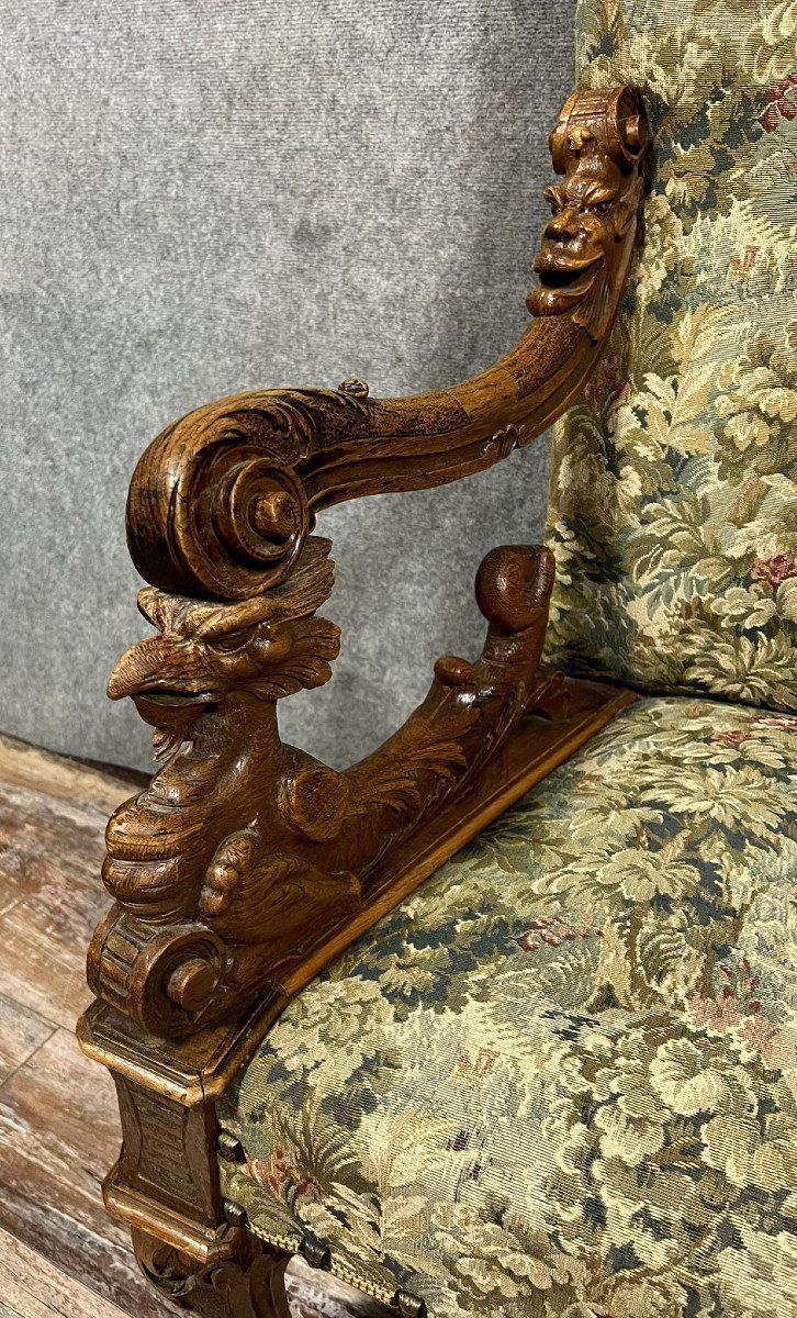 Renaissance throne armchair with slightly curved back in carved walnut.