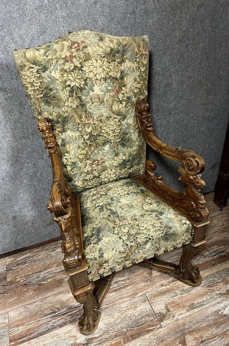 Renaissance throne armchair with slightly curved back in carved walnut.