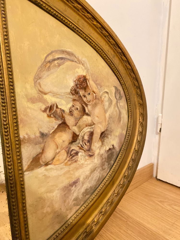 Gilded Oval Bevelled Mirror Surrounded By Two Paintings Of Cherubs 110cm X 70cm