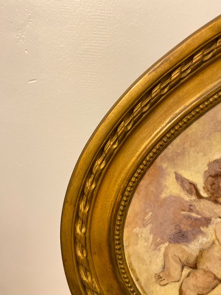 Gilded Oval Bevelled Mirror Surrounded By Two Paintings Of Cherubs 110cm X 70cm