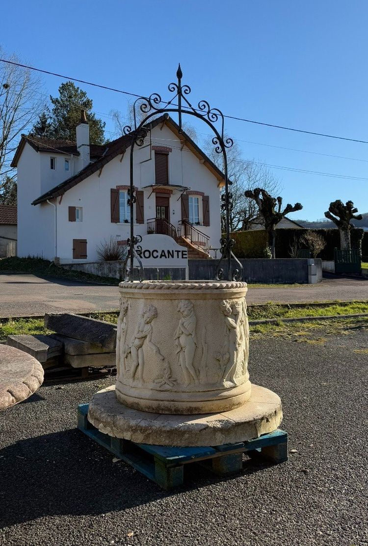 Reconstituted stone well with antique decorations circa 1950