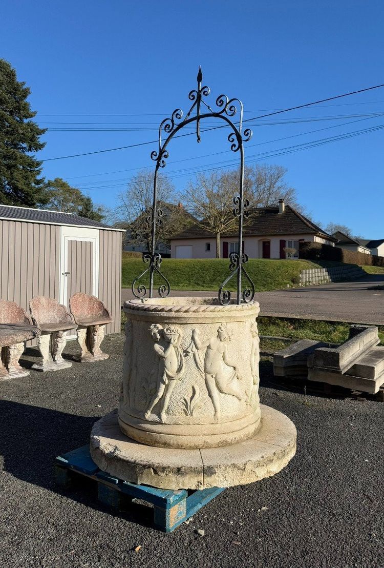 Reconstituted stone well with antique decorations circa 1950