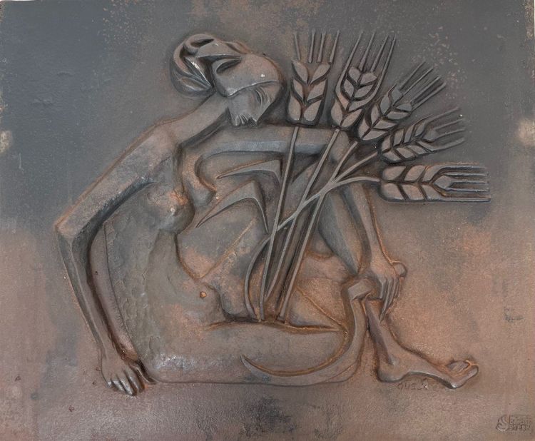 Modernist cast-iron plaque depicting a Nude Woman Holding a Scythe and Wheat Spikes.