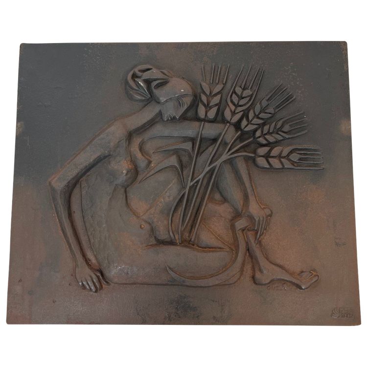 Modernist cast-iron plaque depicting a Nude Woman Holding a Scythe and Wheat Spikes.