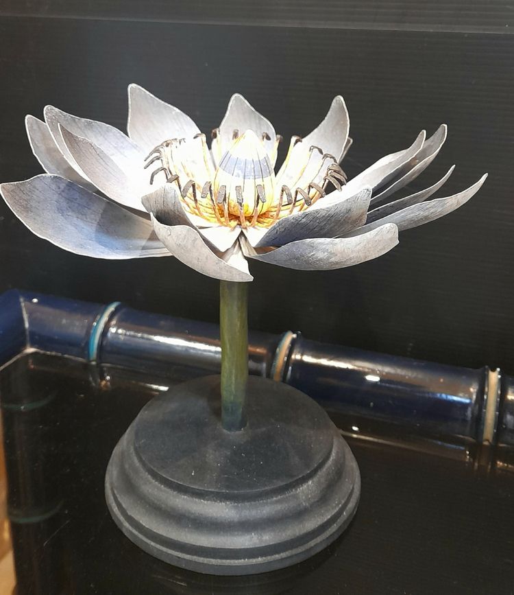 Painted metal water lily mounted on a wooden base