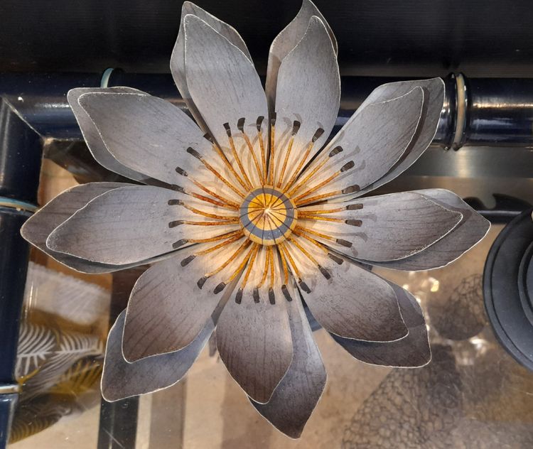 Painted metal water lily mounted on a wooden base