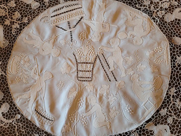 Embroidered pedestal tablecloth on the theme of grape harvests and wine, circa 1900