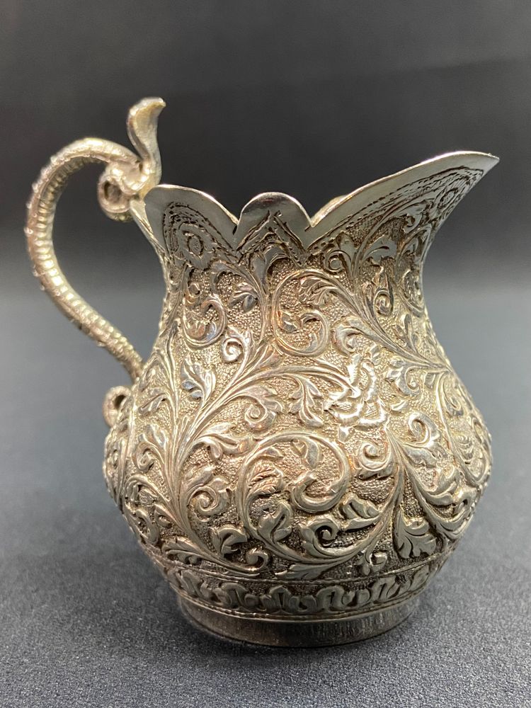 Milk jug in richly chased solid silver with Indo-Persian design and cobra handle