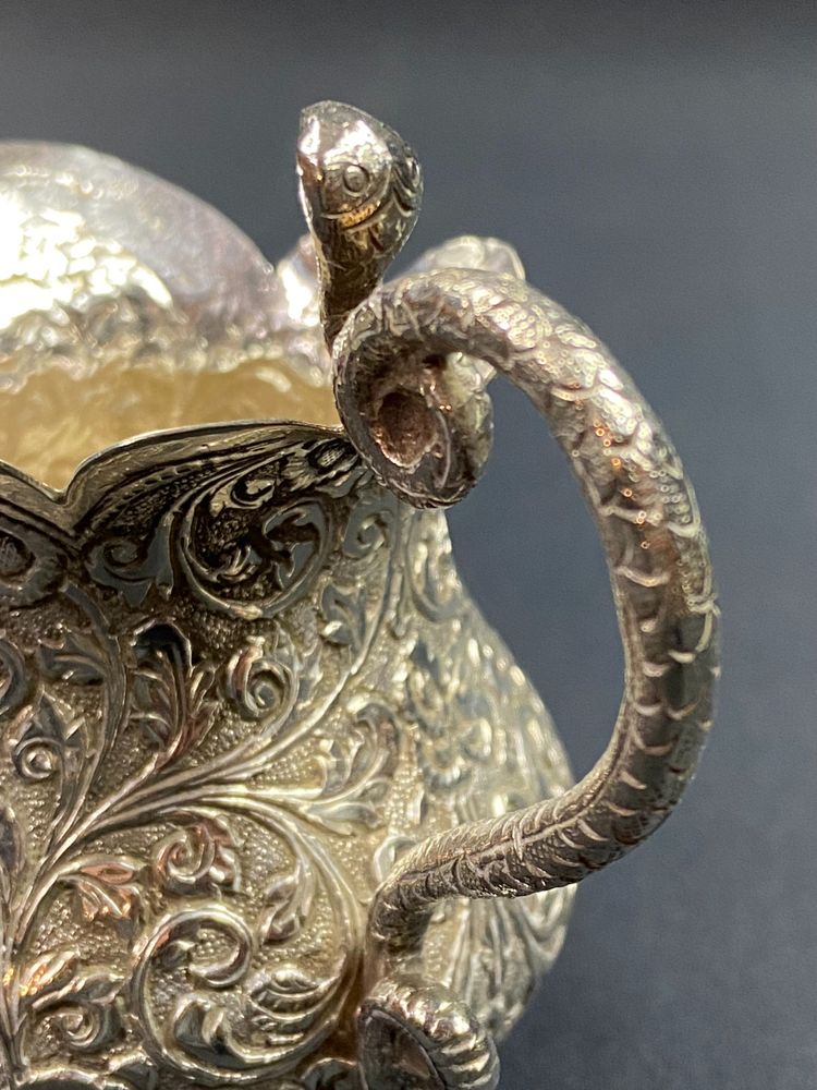 Milk jug in richly chased solid silver with Indo-Persian design and cobra handle