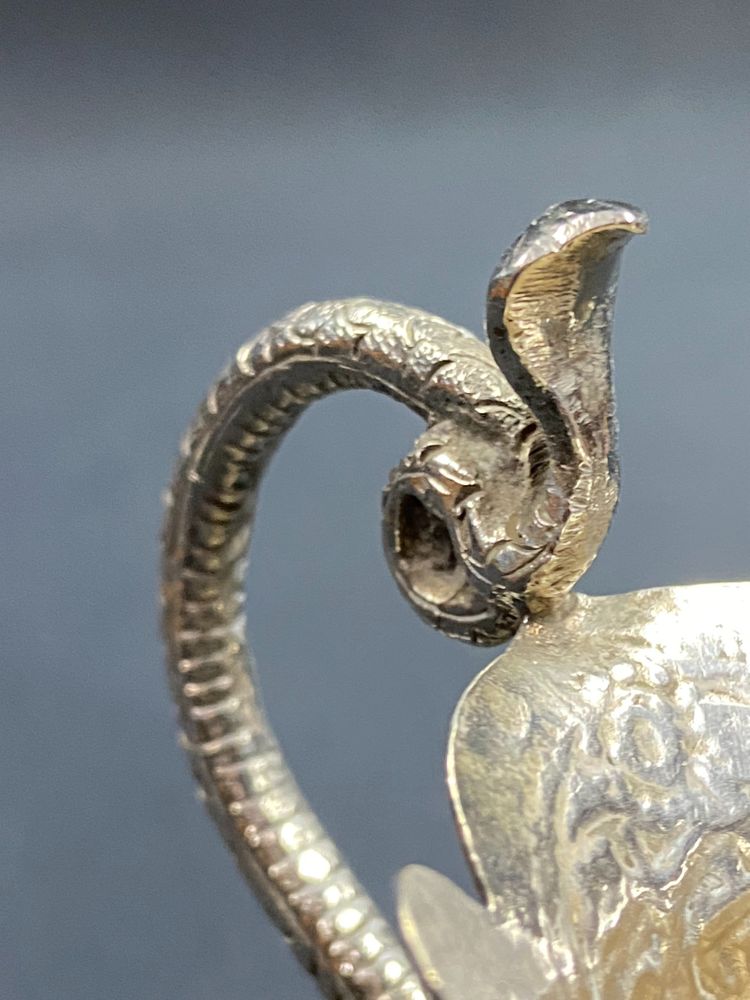 Milk jug in richly chased solid silver with Indo-Persian design and cobra handle