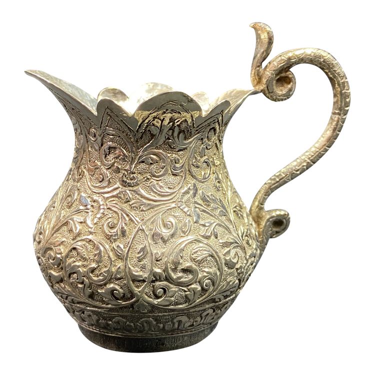 Milk jug in richly chased solid silver with Indo-Persian design and cobra handle