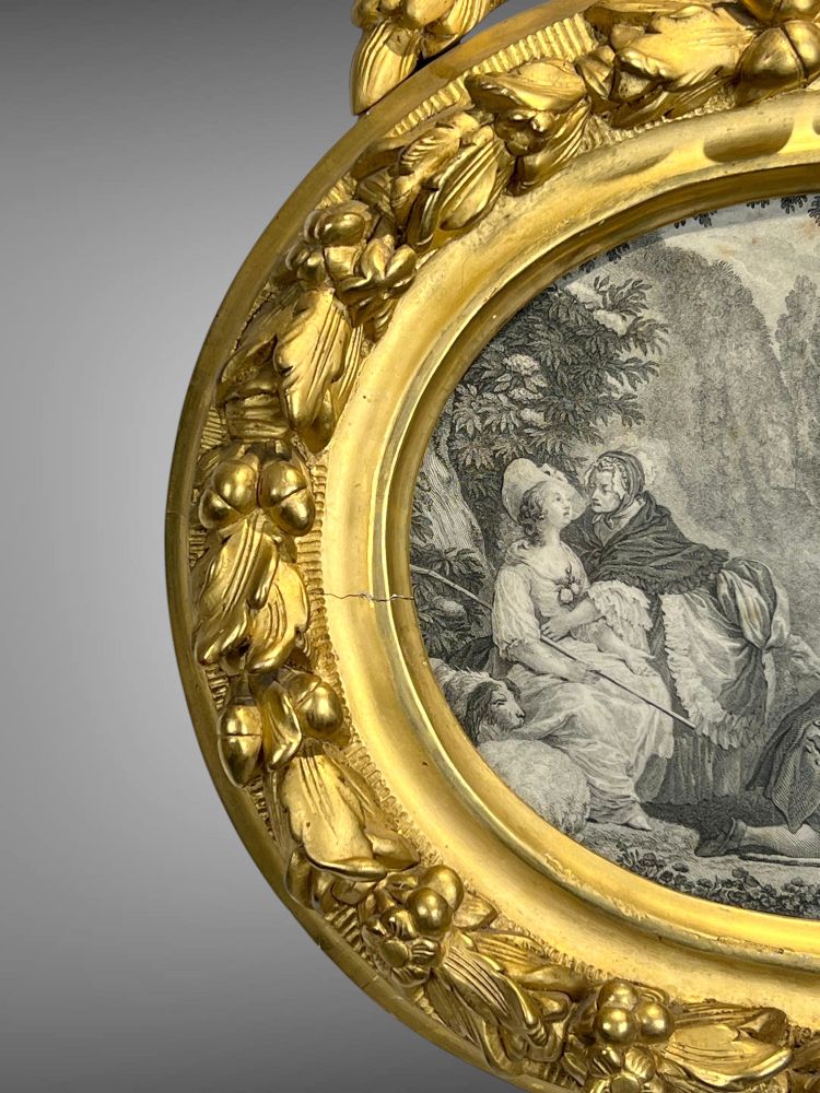 EIGHTEENTH CENTURY OVAL FRAME IN GILDED SCULPTTED WOOD AND ITS FURNACED FRONTIER