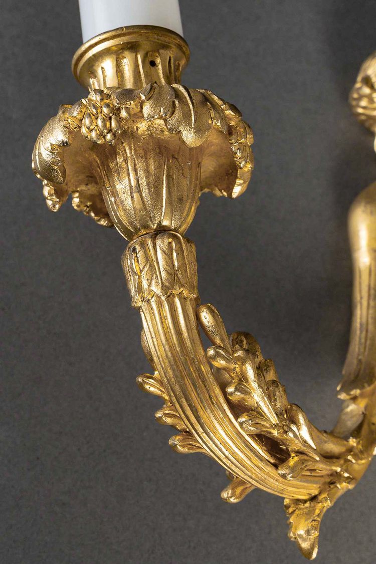 A pair of Louis XVI style Aux Termes de Femmes sconces in chiseled and gilt bronze circa 1850-1870