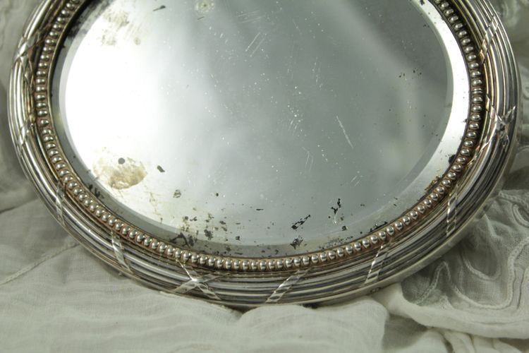 Small oval beveled mirror with solid silver frame circa 1900