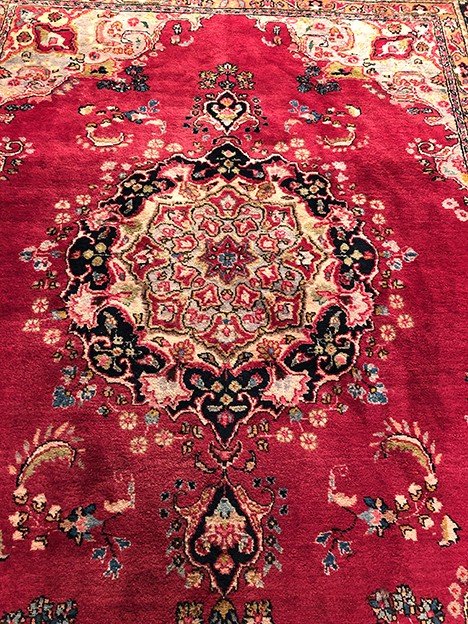 Iranian wool carpet with central medallion decoration on pink background