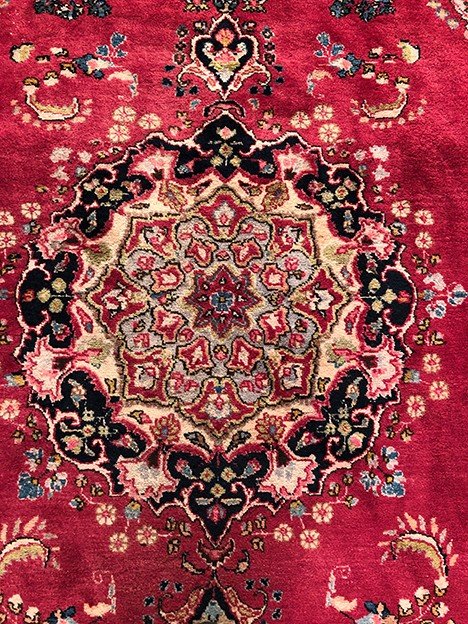 Iranian wool carpet with central medallion decoration on pink background