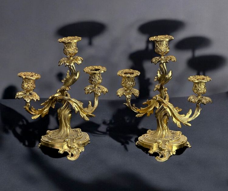 PAIR OF LATE 19TH CENTURY GILT-BRONZE THREE-BRANCH CANDLESTICKS IN LOUIS XV STYLE