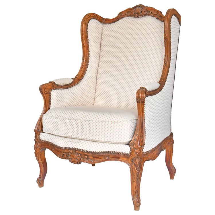 Louis XV style wing chair in richly carved wood