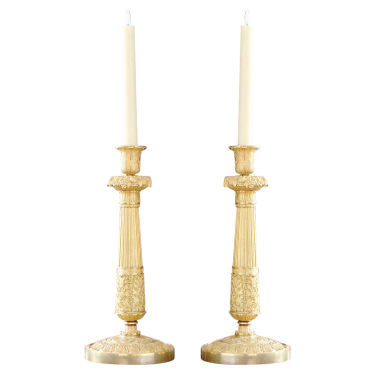 Pair of candlesticks in gilded and chiseled bronze