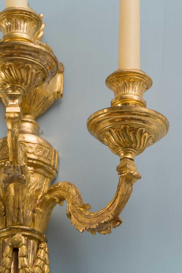 Pair of Louis XVI period gilt and chased bronze wall lights