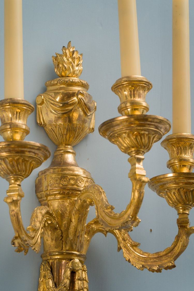 Pair of Louis XVI period gilt and chased bronze wall lights