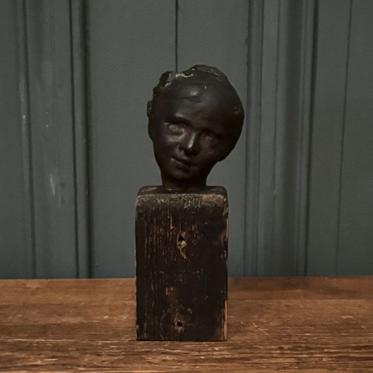 Studio plaster by Charles Filleul depicting a young boy on a wooden base