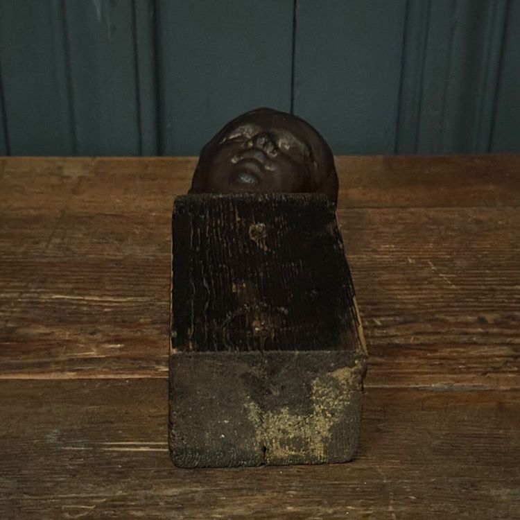 Studio plaster by Charles Filleul depicting a young boy on a wooden base